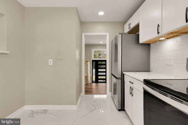 a kitchen with stainless steel appliances a refrigerator and a stove