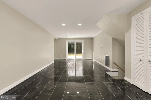 a view of a hallway with wooden floor and chair