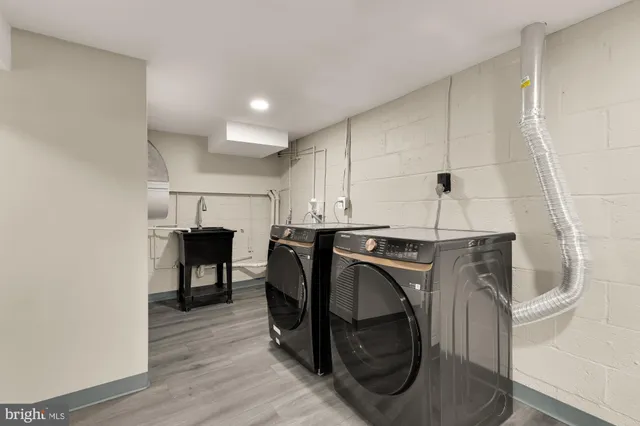 a utility room with cabinets dryer and washer