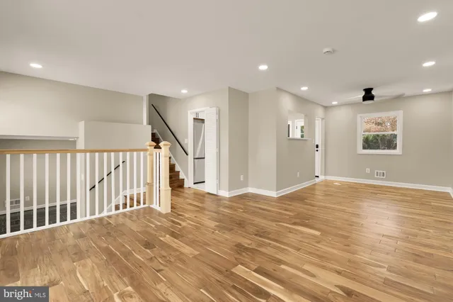 a view of empty room with wooden floor