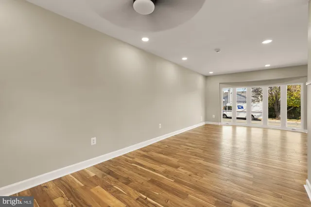 a view of a room with wooden floor and window