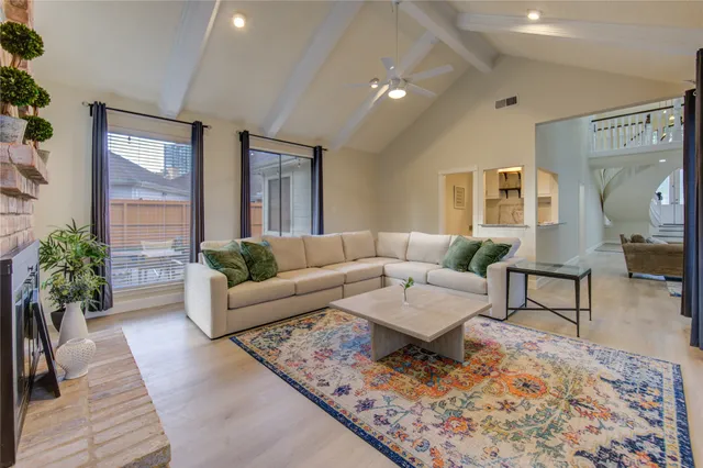 a living room with furniture and a potted plant