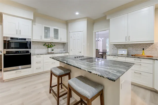 a kitchen with white cabinets and white appliances