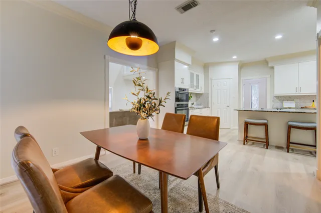 a view of a dining room with furniture and chandelier