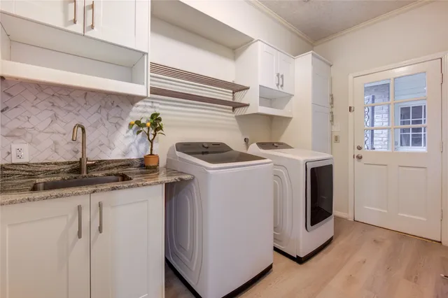 a spacious bedroom with a bed and a chandelier