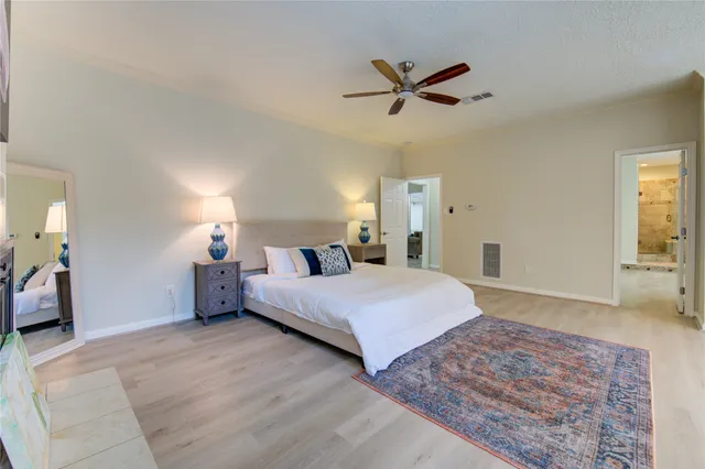 a spacious bedroom with a bed and a fireplace