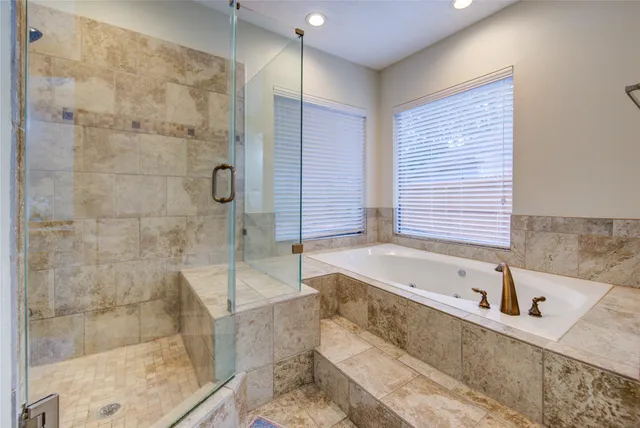 a bathroom with double vanity sinks and a mirror