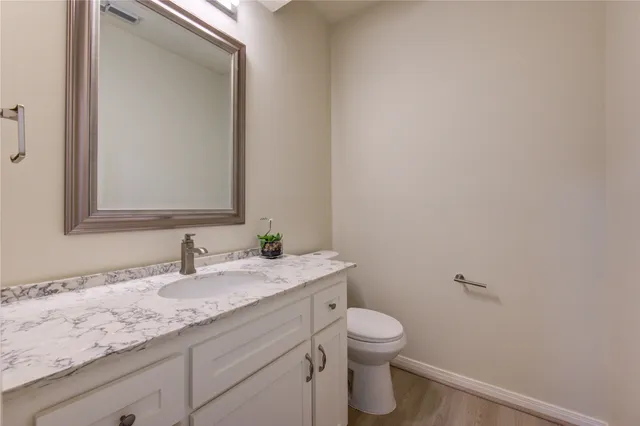 a view of a dining room with furniture and a chandelier
