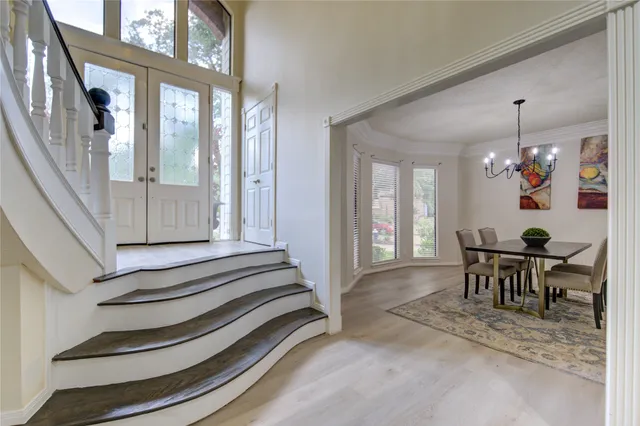 a view of staircase with wooden floor and a rug