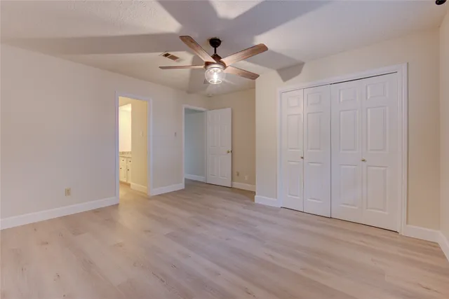 a view of room with window and ceiling fan