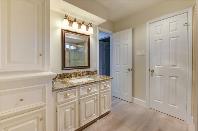 a bathroom with a granite countertop tub sink and shower