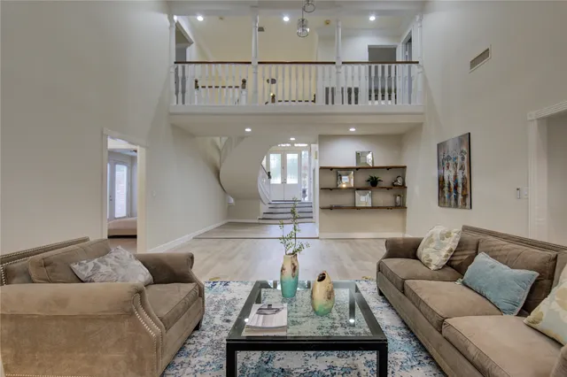 a living room with furniture and a view of kitchen
