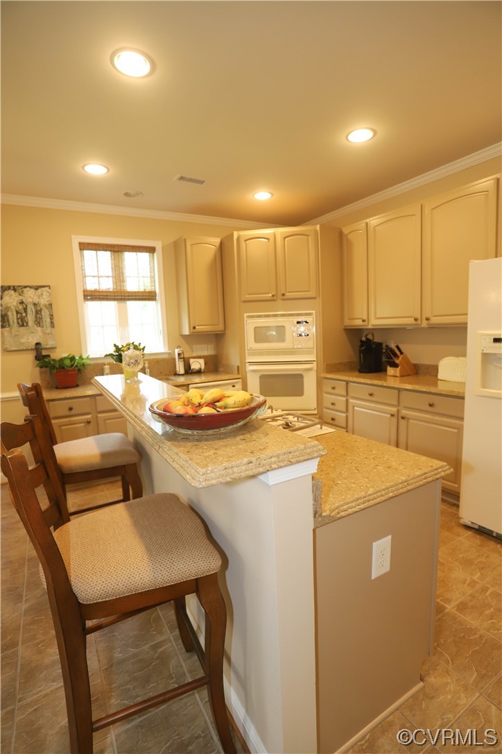 4748 Westhampton Williamsburg, VA 23188 - Photo 17 of 39 a kitchen with stainless steel appliances granite countertop a stove a sink a refrigerator white cabinets and couches with wooden floor