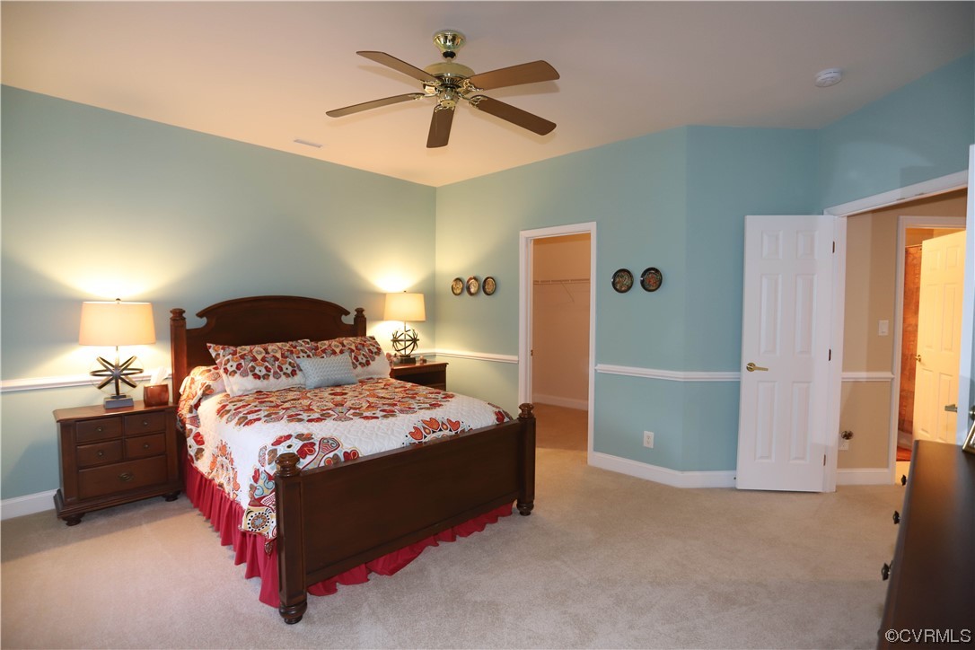 4748 Westhampton Williamsburg, VA 23188 - Photo 33 of 39 a bedroom with a bed and a chandelier