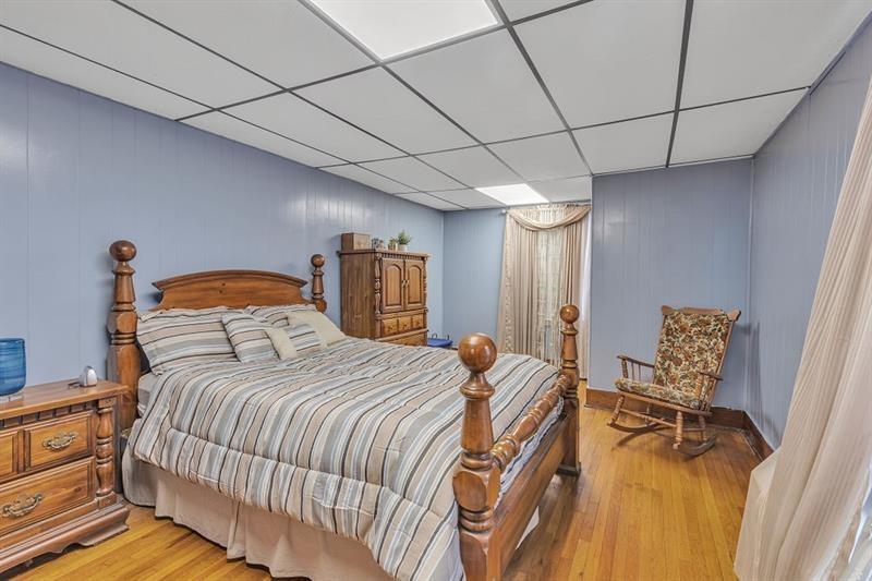 3159 Brodhead Road Aliquippa, PA 15001 - Photo 10 of 30 a bedroom with a bed and wooden floor