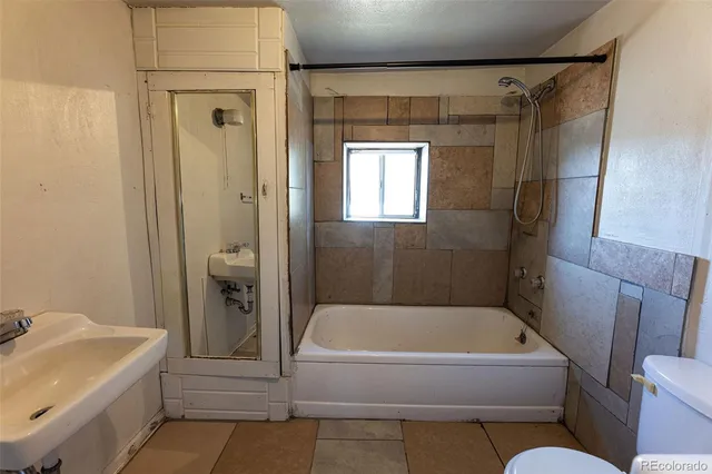 a bathroom with a tub and shower