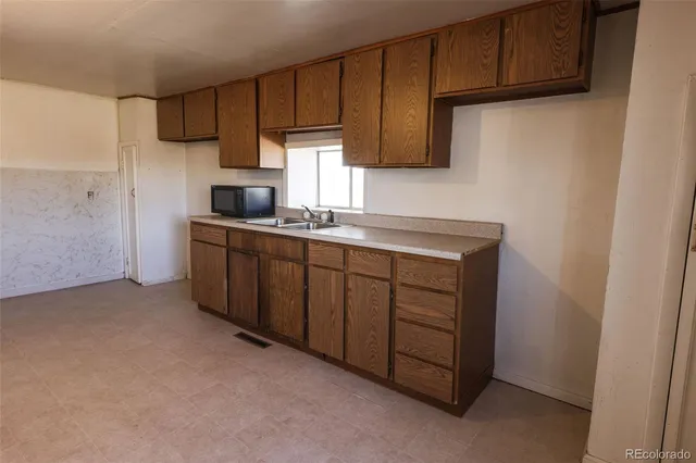 a kitchen with a sink cabinets and appliances