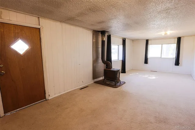 an empty room with windows and closet