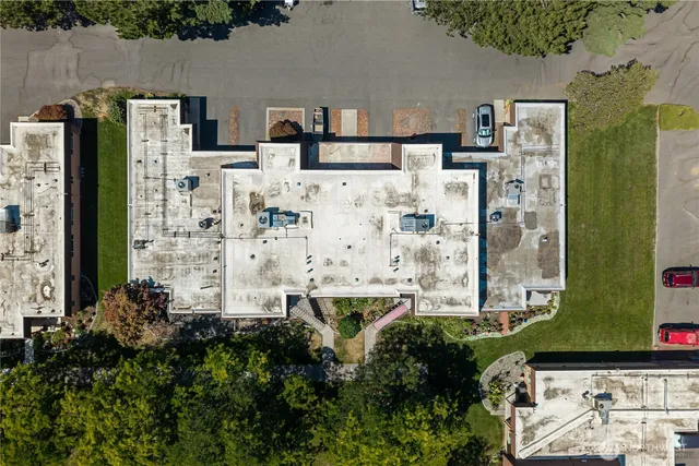a aerial view of multi story residential apartment building with yard