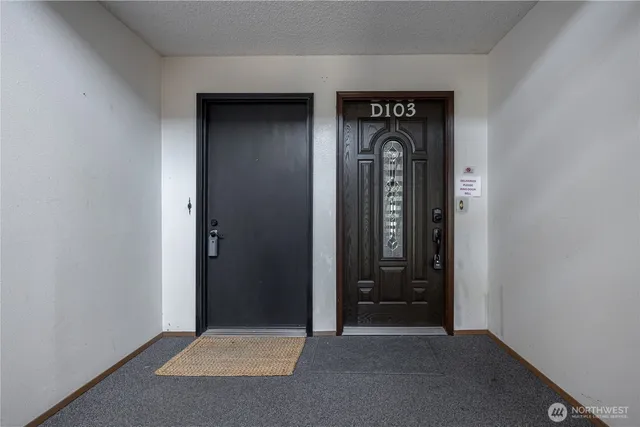 a view of a hallway with wooden door