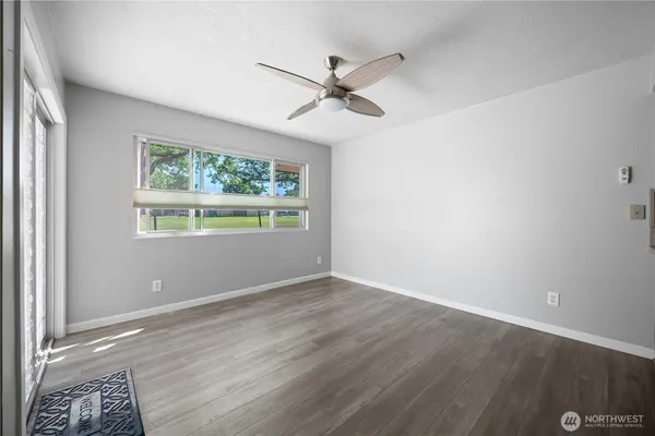a view of a kitchen with a sink a refrigerator and wooden floor