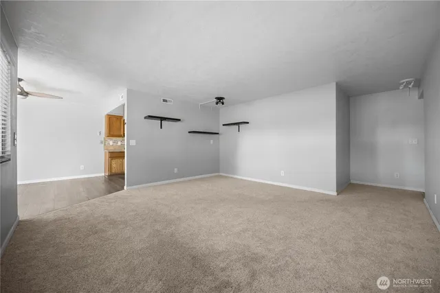 a view of an empty room with windows