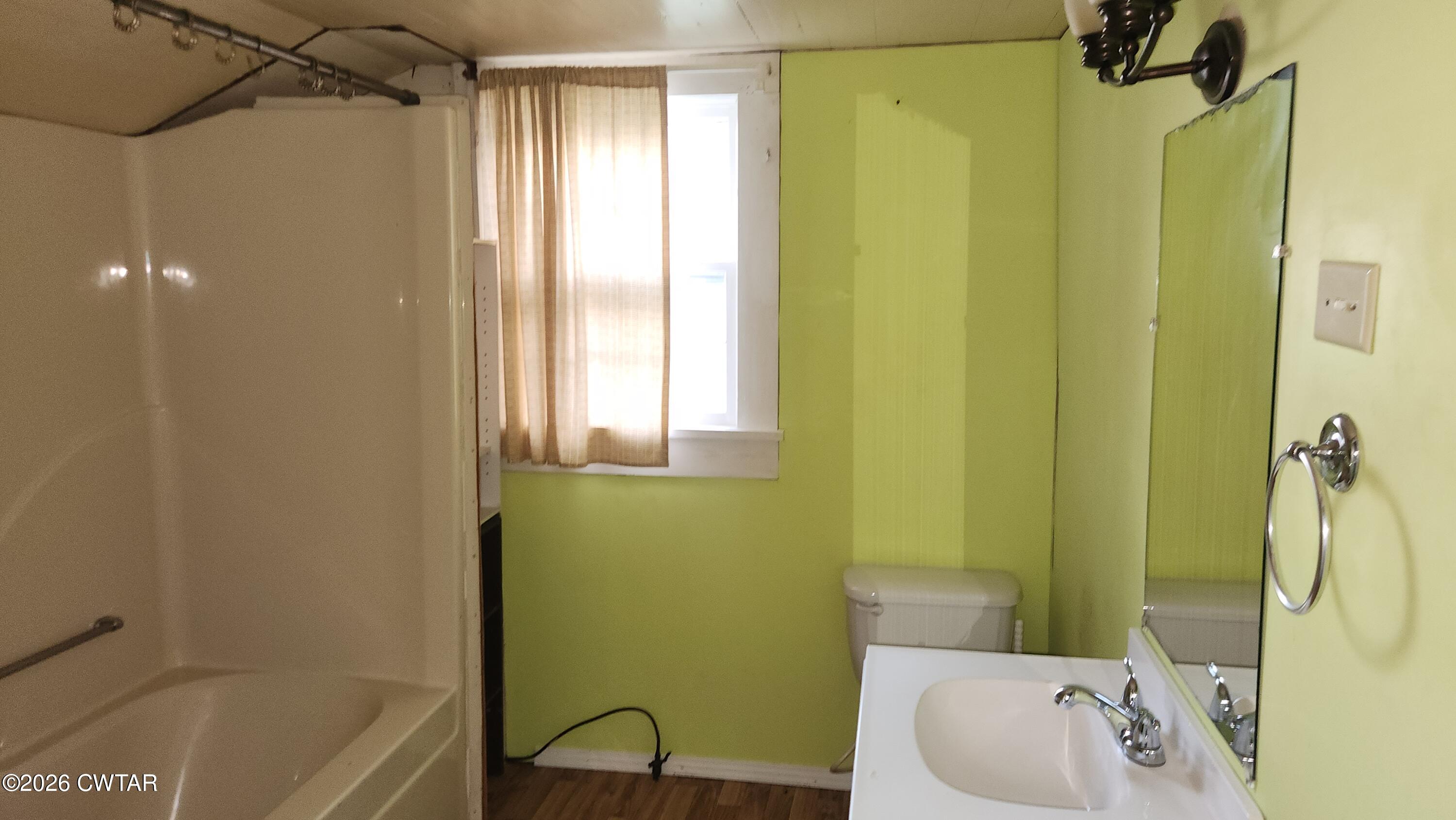 8633 Stanton Koko Road Stanton, TN 38069 - Photo 8 of 10 a bath room with a sink and a tub