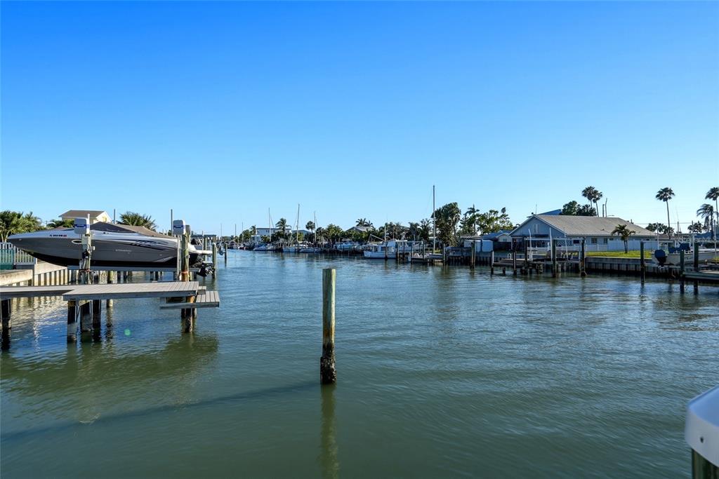 534 Crystal Drive Madeira Beach, FL 33708 - Photo 56 of 68 a view of a lake with boats and trees in the background