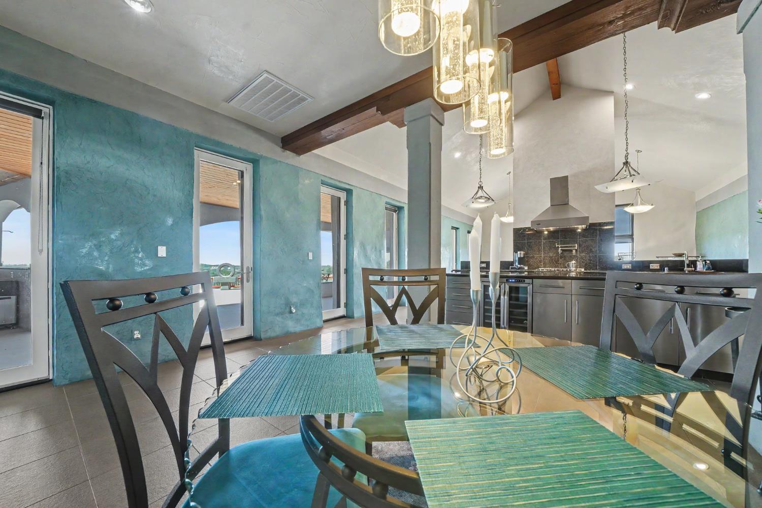15070 Willow Creek Road Ione, CA 95640 - Photo 27 of 66 a view of a dining room with furniture a chandelier and wooden floor