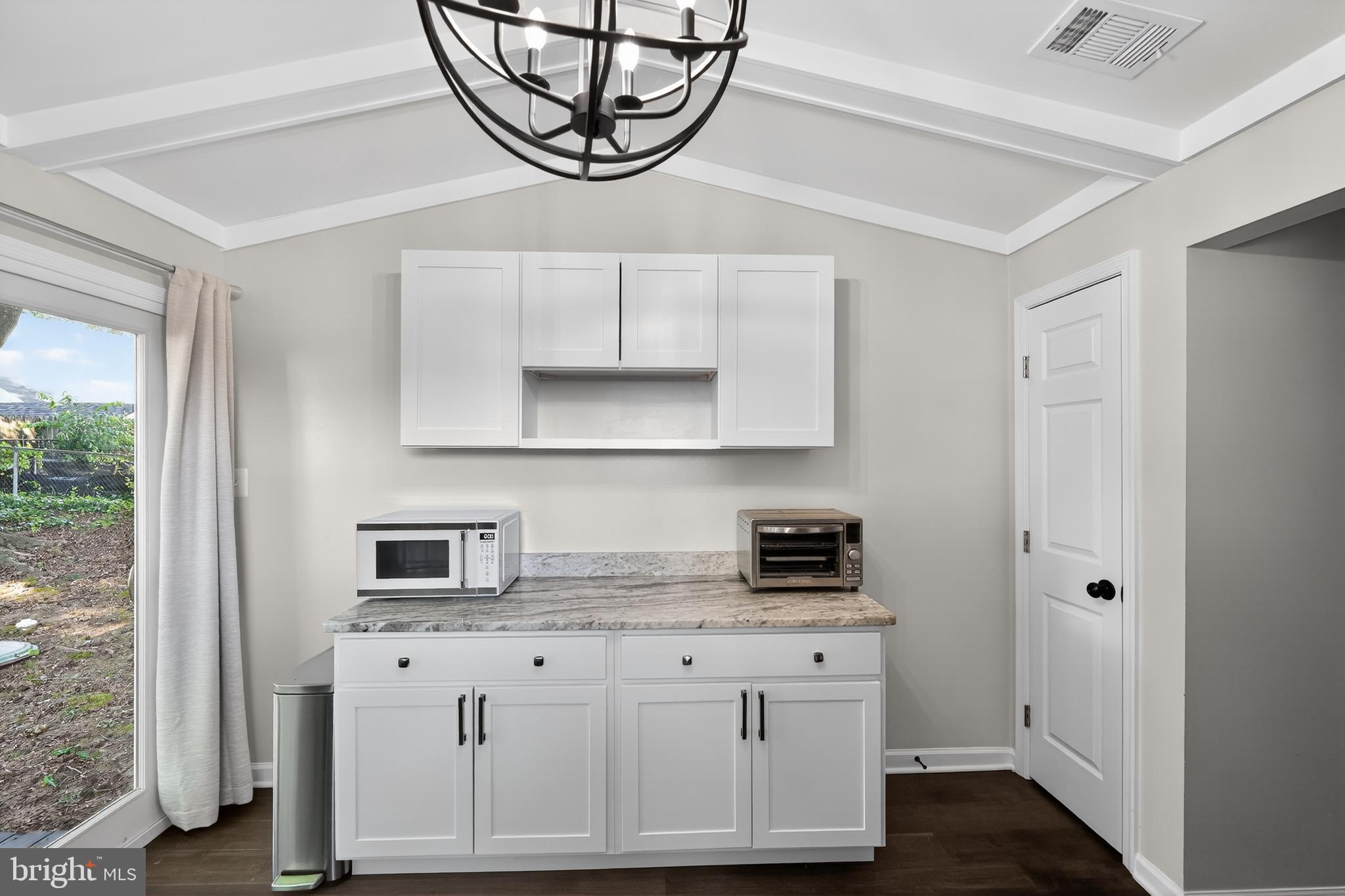 3670 5th Avenue Edgewater, MD 21037 - Photo 15 of 60 a kitchen with stainless steel appliances granite countertop a sink a stove a refrigerator a microwave oven with cabinets and wooden floor