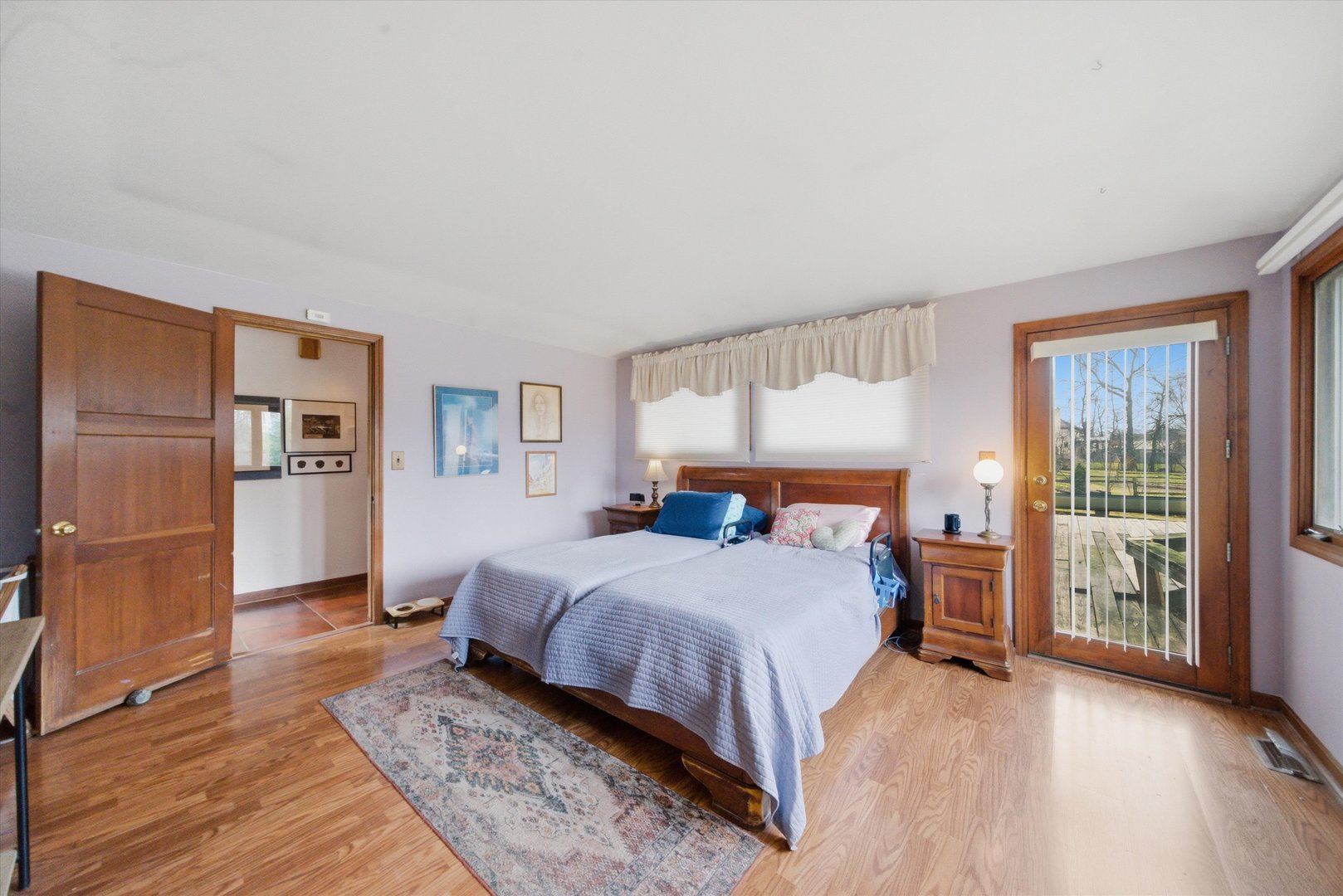 330 Ferndale Avenue Elmhurst, IL 60126 - Photo 12 of 36 a bedroom with a large bed and a wooden floor