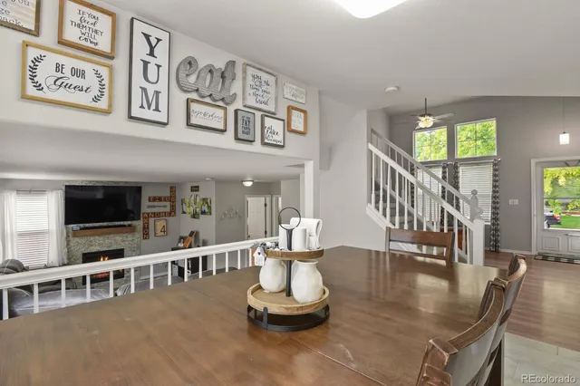 a dining room with furniture a rug and a large window