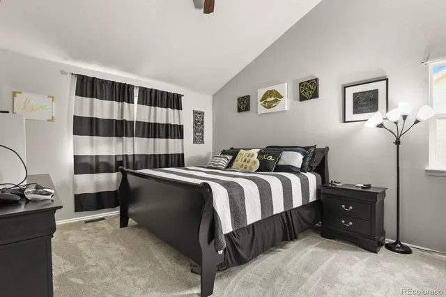 a spacious bedroom with a bed and a window