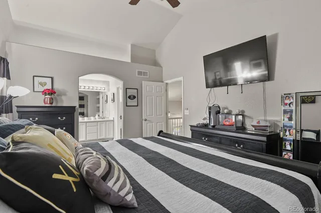 a bedroom with a bed and a flat screen tv