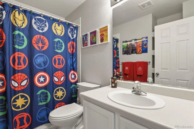 a bathroom with a sink mirror and vanity