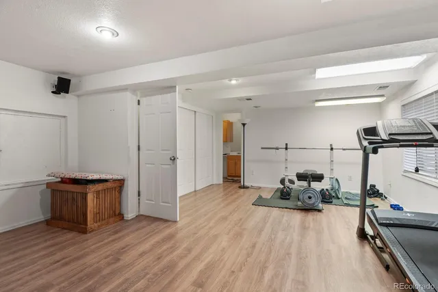 a view of a room with wooden floor and furniture