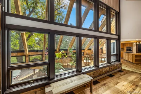 a view of a room with wooden floor and windows