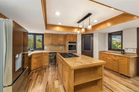 a kitchen with stainless steel appliances granite countertop a sink and a stove