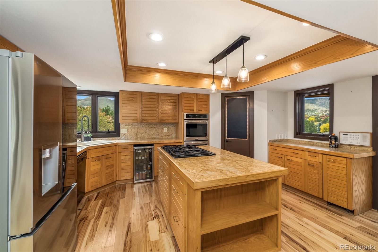 6 Blue Grouse Ridge Road Littleton, CO 80127 - Photo 13 of 50 a kitchen with stainless steel appliances granite countertop a sink and a stove