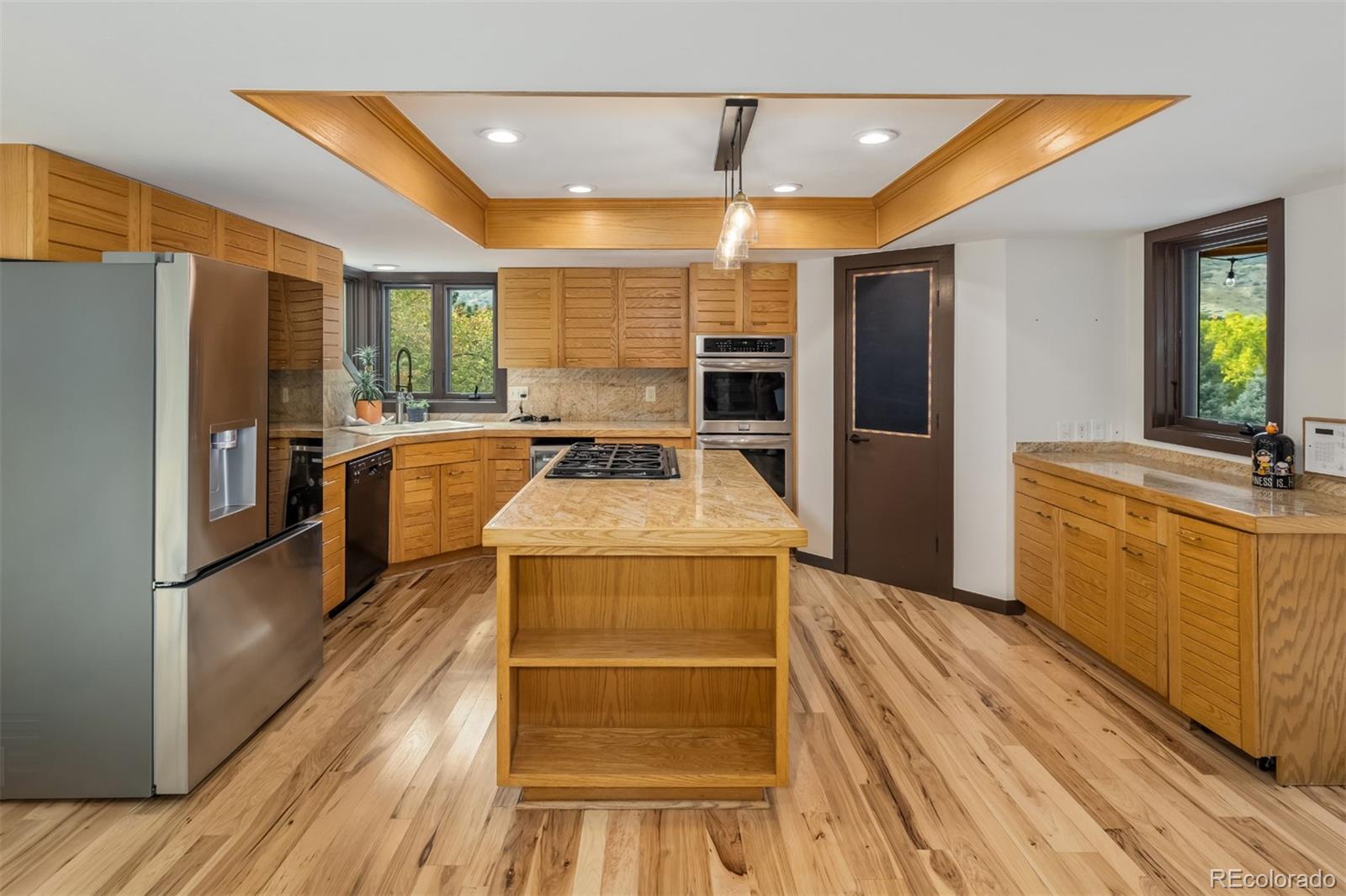 6 Blue Grouse Ridge Road Littleton, CO 80127 - Photo 14 of 50 a kitchen with sink refrigerator and stove