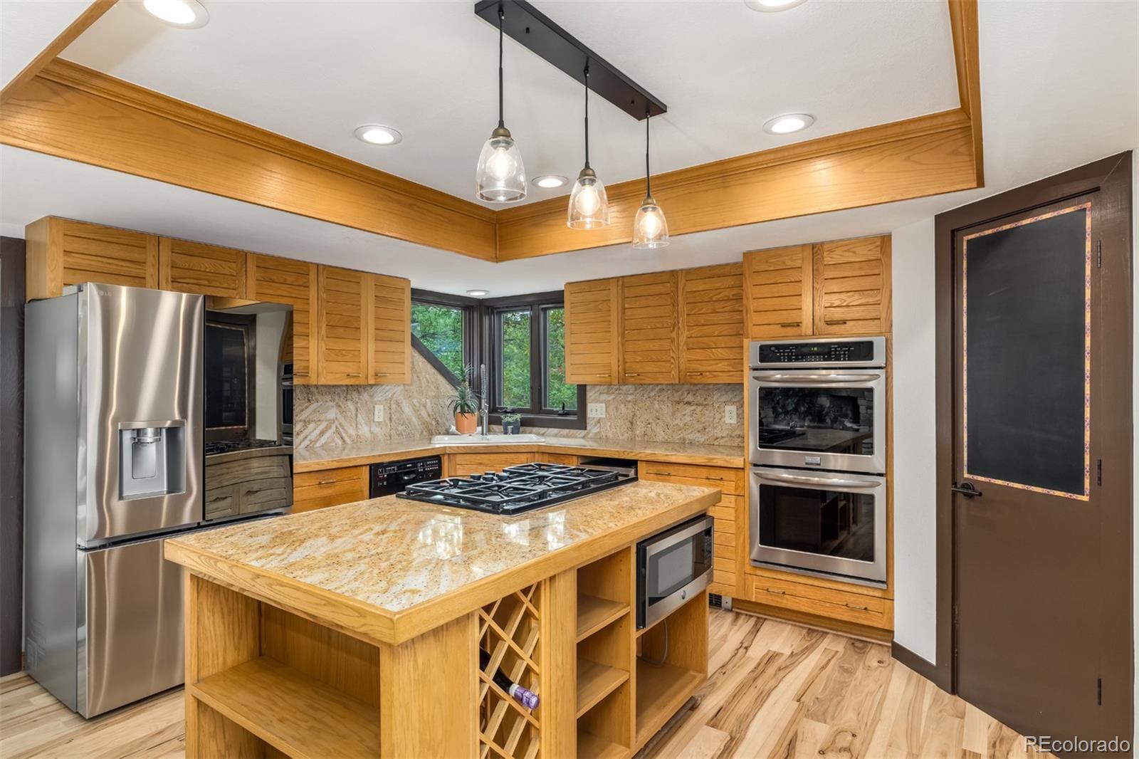 6 Blue Grouse Ridge Road Littleton, CO 80127 - Photo 15 of 50 a kitchen with stainless steel appliances granite countertop a stove and a refrigerator