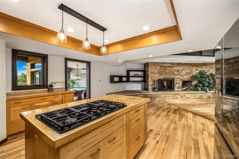 a kitchen with stainless steel appliances granite countertop a stove and a wooden cabinets