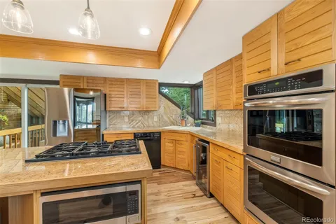 a kitchen with stove and cabinets