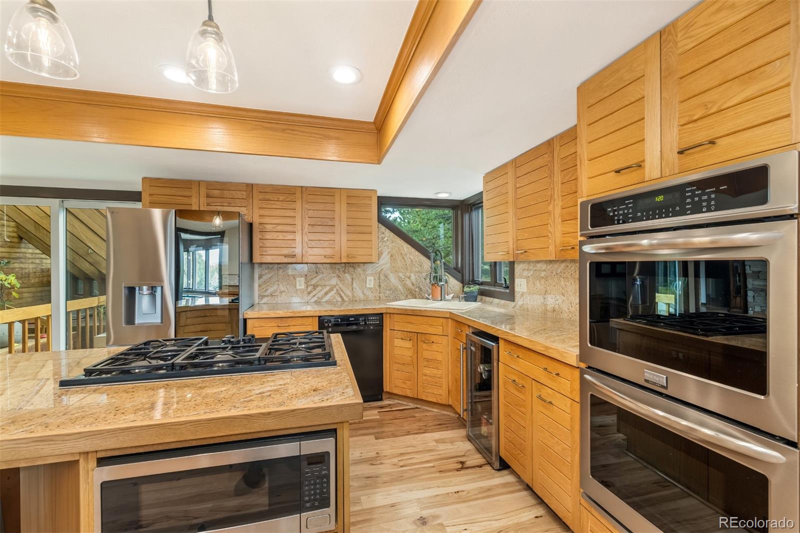 6 Blue Grouse Ridge Road Littleton, CO 80127 - Photo 17 of 50 a kitchen with stove and cabinets