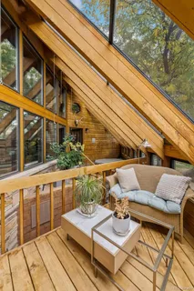 a view of balcony with wooden floor and outdoor seating