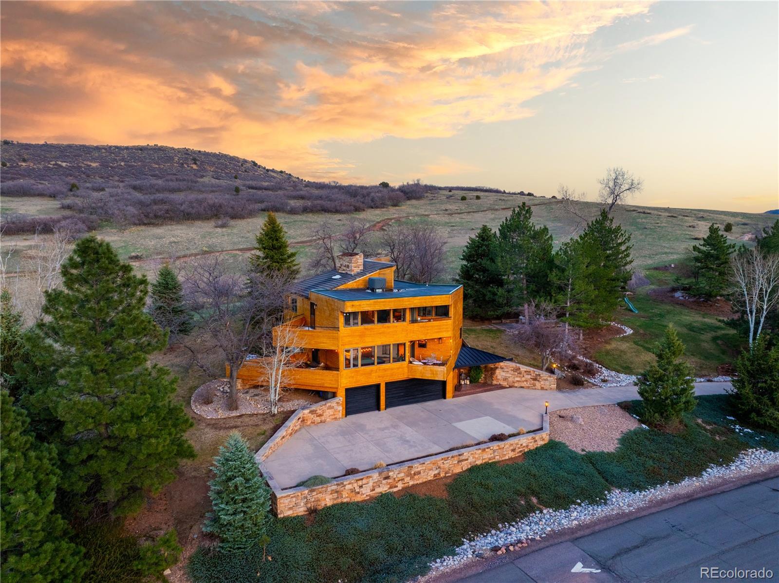6 Blue Grouse Ridge Road Littleton, CO 80127 - Photo 2 of 50 an aerial view of a house with a garden