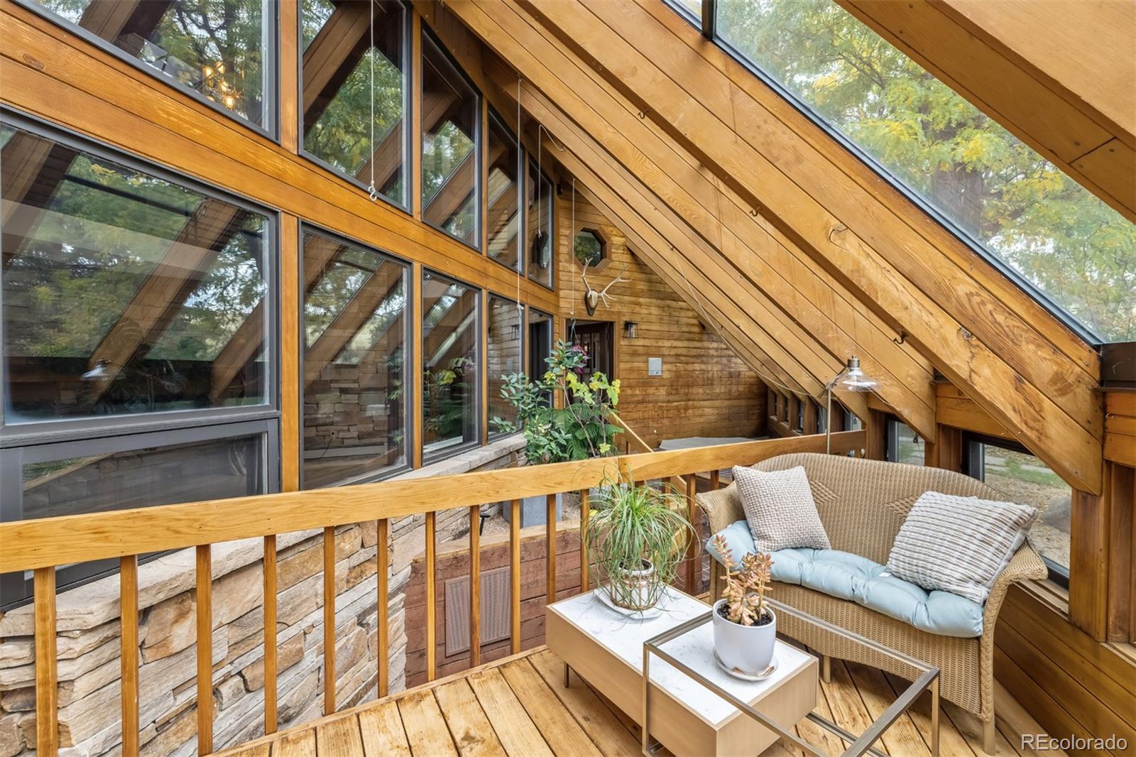 6 Blue Grouse Ridge Road Littleton, CO 80127 - Photo 21 of 50 a view of balcony with wooden floor and outdoor seating