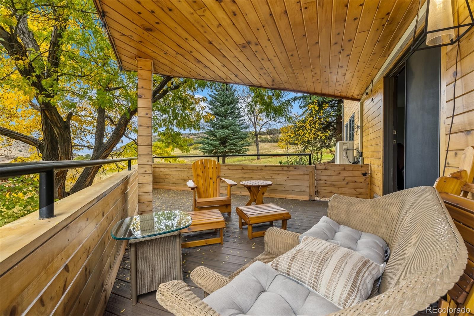 6 Blue Grouse Ridge Road Littleton, CO 80127 - Photo 28 of 50 a living room with furniture and a floor to ceiling window