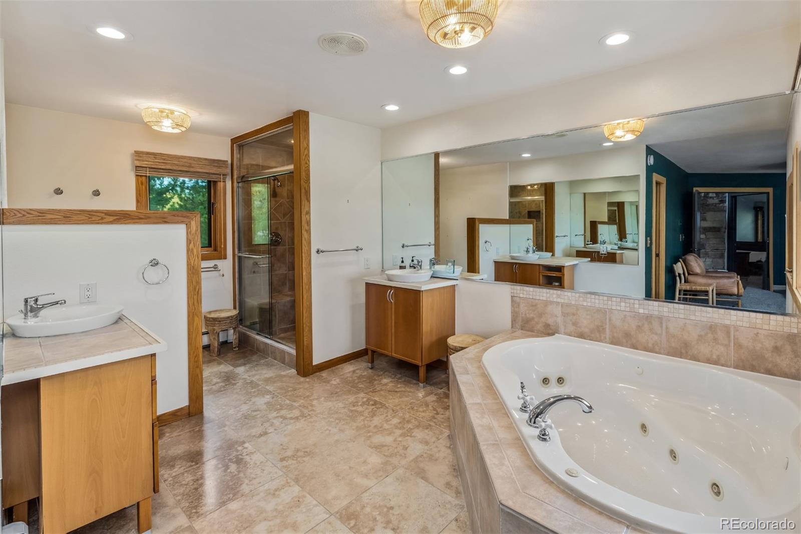 6 Blue Grouse Ridge Road Littleton, CO 80127 - Photo 34 of 50 a large bathroom with a tub double vanity