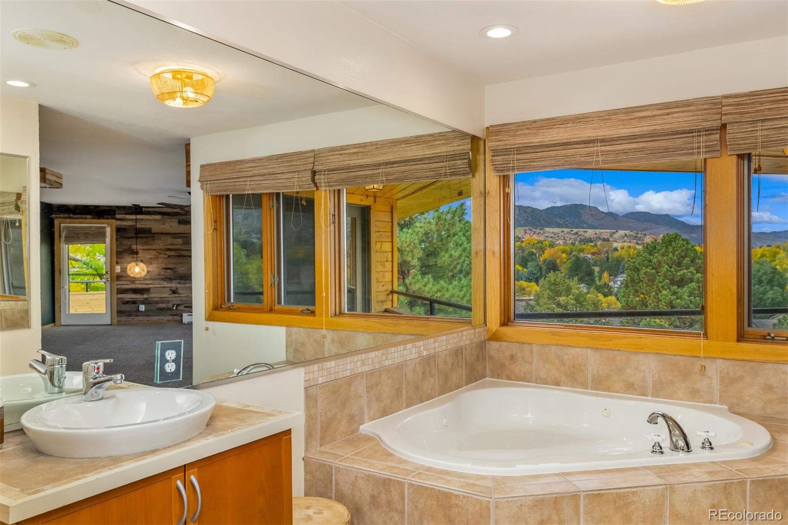 6 Blue Grouse Ridge Road Littleton, CO 80127 - Photo 35 of 50 a bathroom with a tub and a large window
